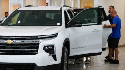 A customer views a new Chevrolet Traverse vehicle for sale at a Chevrolet dealership in Miami, Florida in early April. Despite tariffs raising the cost to build or import vehicles sold at American dealerships, average car prices have stayed mostly unchanged so far this year.