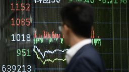 A man walks past a screen showing Chinese stock market movements in Beijing on April 7, 2025. Asian equities collapsed on a black Monday on April 7 for markets after China hammered the United States with its own hefty tariffs, ramping up a trade war many fear could spark a recession. (Photo by WANG Zhao / AFP) (Photo by WANG ZHAO/AFP via Getty Images)          