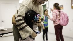 UNDISCLOSED LOCATION, CONNECTICUT - APRIL 3: A child of immigrants hugs a teacher following "homework club" at a community center on April 3, 2025 at an undisclosed location, Connecticut. Although some of the children at the event originally arrived to the United States as asylum seekers, most were born in the United States to immigrant parents. Many immigrants, including legal green card holders, have expressed extreme anxiety as the Trump istration enacts more stringent immigration policies, including mass deportations of undocumented people living in the United States.  (Photo by John Moore/Getty Images)