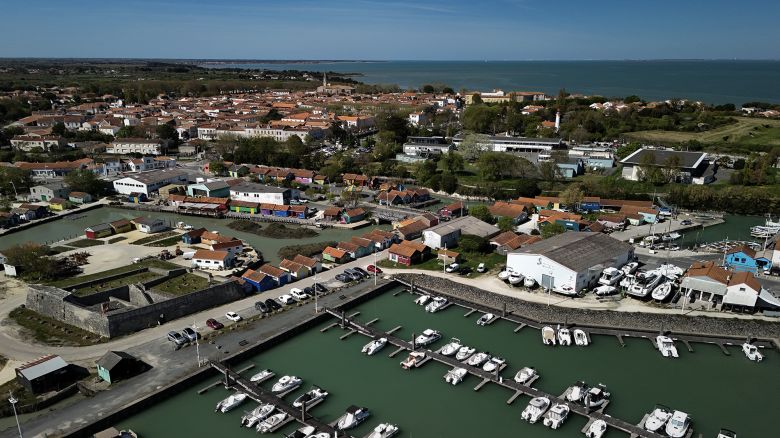 This aerial view shows boats moored in the harbour of Le Chateau-d'Oleron with the city in background, on the Island of Oleron, southwestern France, on April 8, 2025. On April 8, 2025, the online holiday rental platform Airbnb was ordered to pay more than 8.6 million euros (9.4 US dollars) to the municipality of Ile d'Oleron (Charente-Maritime) for violations relating to tourist tax. (Photo by Philippe LOPEZ / AFP) (Photo by PHILIPPE LOPEZ/AFP via Getty Images)          