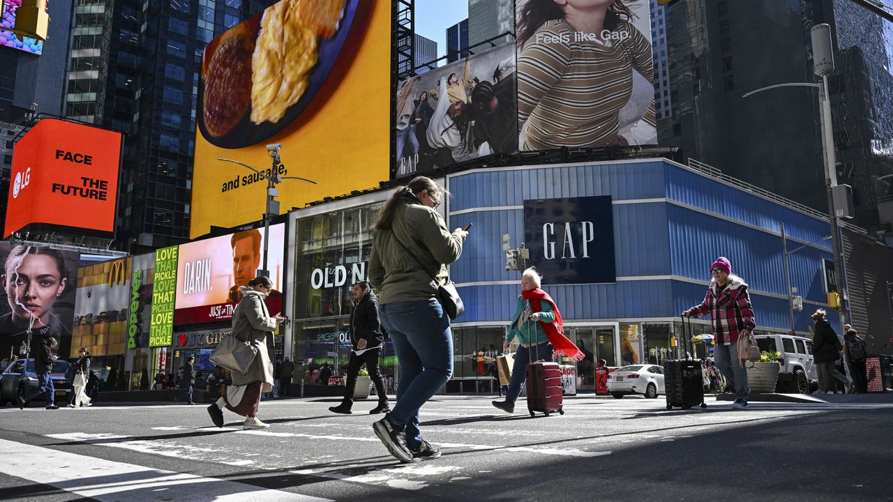 Old Navy and Gap retail stores are seen as people walk through Times Square in New York City on April 9, 2025. US President Donald Trump brushed off global market panic Wednesday after China and the European Union announced retaliatory tariffs, telling Americans to stay "cool" despite his spiraling trade war. Trump dug in after superpower rival Beijing slapped massive 84 percent levies on US goods, just hours after his latest salvo of tariffs took effect on dozens of trading partners around the world. (Photo by ANGELA WEISS / AFP) (Photo by ANGELA WEISS/AFP via Getty Images)          