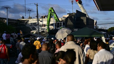 People wait outside the Jet Set nightclub following the collapse of its roof in Santo Domingo on April 9, 2025. Rescuers raced to find survivors on April 8, 2025, among the rubble of a Dominican Republic nightclub where at least 79 people, including a former Major League Baseball star, were killed when the roof collapsed. (Photo by MARTIN BERNETTI / AFP) (Photo by MARTIN BERNETTI/AFP via Getty Images)          