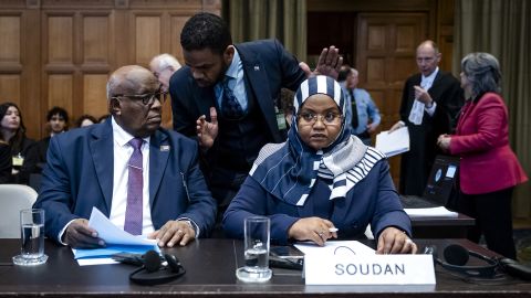 Muawia Osman Mohamed Khair (L), Sudan's acting Minister of Justice, and Sudanese ambassador to the Netherlands Omaima Alsharief wait for the start of a hearing before the International Court of Justice in The Hague, on Thursday.
