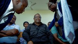 Tanzania's main opposition leader Tundu Lissu (C) speaks with his lawyers at the magistrate's court in Dar es Salaam on April 10, 2025. Tanzania's main opposition leader Tundu Lissu was charged with treason on April 10, 2025 a day after being detained following a rally in the country's south, one of his lawyers told AFP.