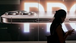 A woman lines up outside a store selling the Apple iPhone 16 in Jakarta on April 11, 2025.