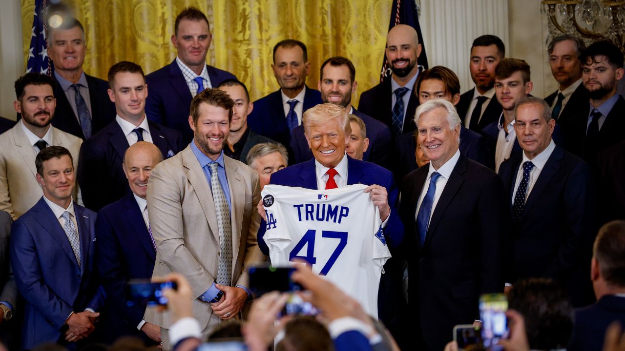 Los Angeles Dodgers pitcher Clayton Kershaw, President Donald Trump and Los Angeles Dodgers Owner and Chairman Mark Walter pose with a jersey presented to Trump as he hosts the 2024 World Series champions in the East Room of the White House on April 7 in Washington, DC.