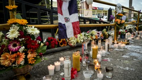 Candles are pictured while friends and relatives pay tribute to the victims in front of the Jet Set nightclub in Santo Domingo on April 11, 2025. Grief-stricken Dominicans began holding funerals for loved ones who were among at least 220 people killed in a nightclub rooftop collapse, even as dozens remained uned for. (Photo by MARTIN BERNETTI / AFP) (Photo by MARTIN BERNETTI/AFP via Getty Images)
