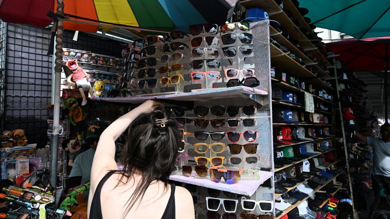 A shopper looks at sunglasses made in China at Santee Alley, in Los Angeles' Fashion District, known for inexpensive imported garments and accessories.