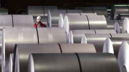 A worker walks among coils of finished steel at a plant in Duisburg, Germany. President Donald Trump imposed 25% tariffs on steel imports, which are set to stick despite a significant ruling a federal court struck impact other tariffs he's imposed.