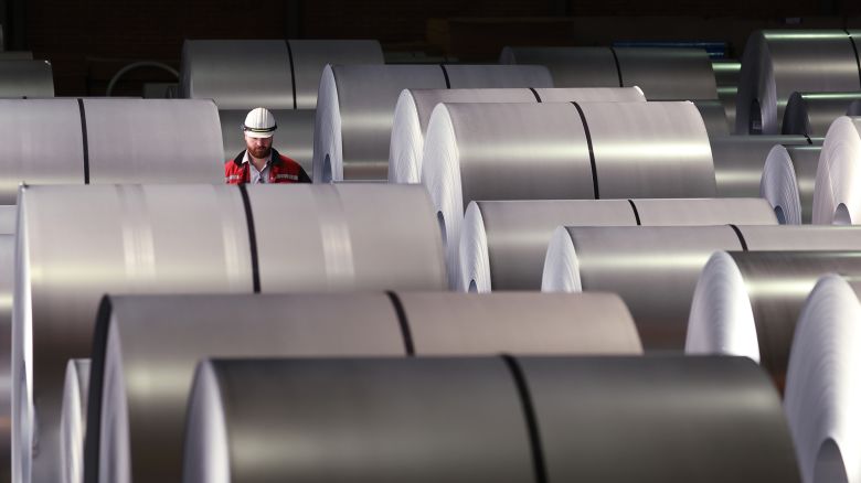 A worker walks among coils of finished steel at a plant in Duisburg, Germany. President Donald Trump imposed 25% tariffs on steel imports, which are set to stick despite a significant ruling a federal court struck impact other tariffs he's imposed.