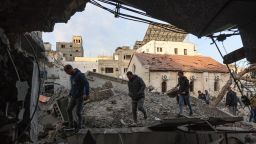 People check the destruction in the aftermath of an Israeli strike on the Al-Ahli hospital in Gaza City on April 13, 2025.