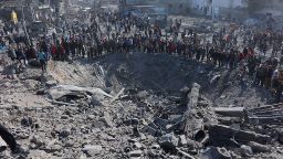 Palestinians gather around a large crater following an Israeli strike on a metalsmith workshop at the Zaytoun neighbouhood in Gaza City on April 13, 2025. (Photo by Omar AL-QATTAA / AFP) (Photo by OMAR AL-QATTAA/AFP via Getty Images)          