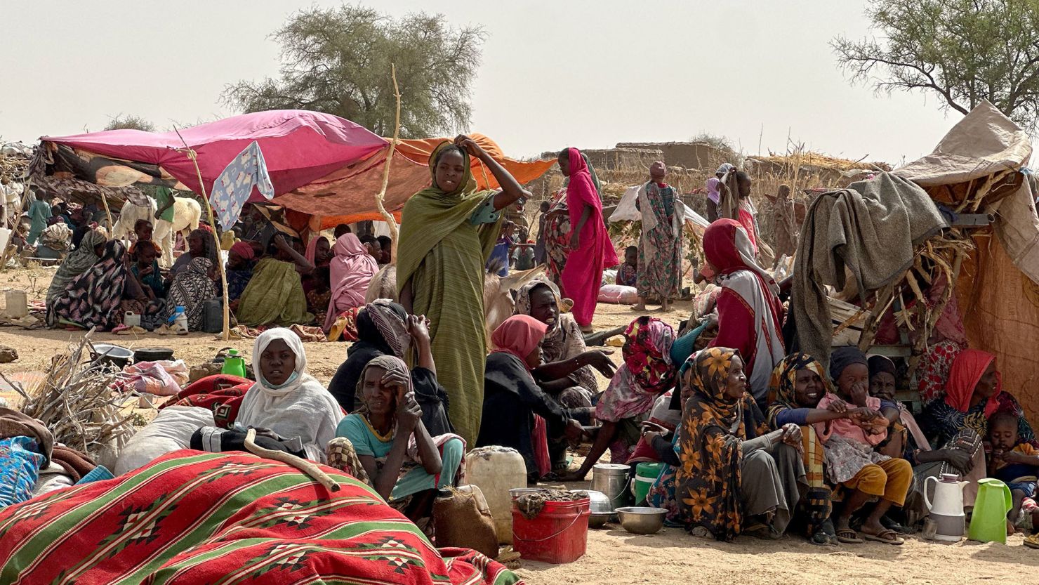 People who fled the Zamzam camp for the internally displaced after it fell under RSF control, rest in a makeshift encampment in an open field near the town of Tawila in war-torn Sudan's western Darfur region on April 13, 2025.