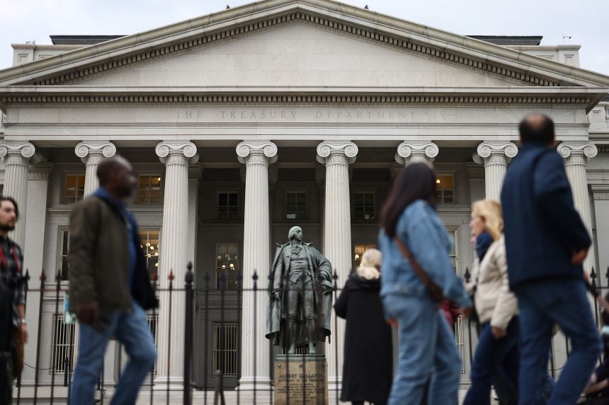 Members of the general public walk past the Treasury Department on April 10, 2025 in Washington, DC.