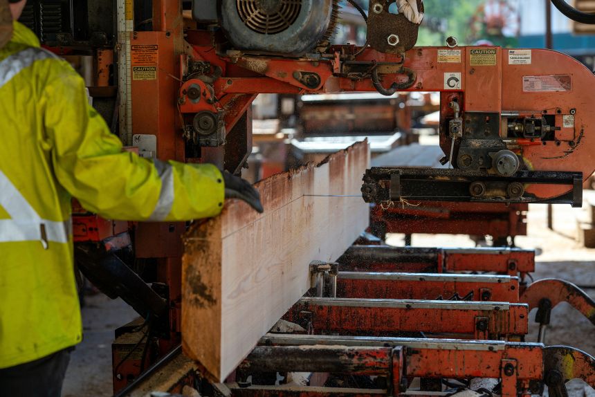 A worker cuts lumber at a saw mill near Sooke, British Columbia, on April 11, 2025.