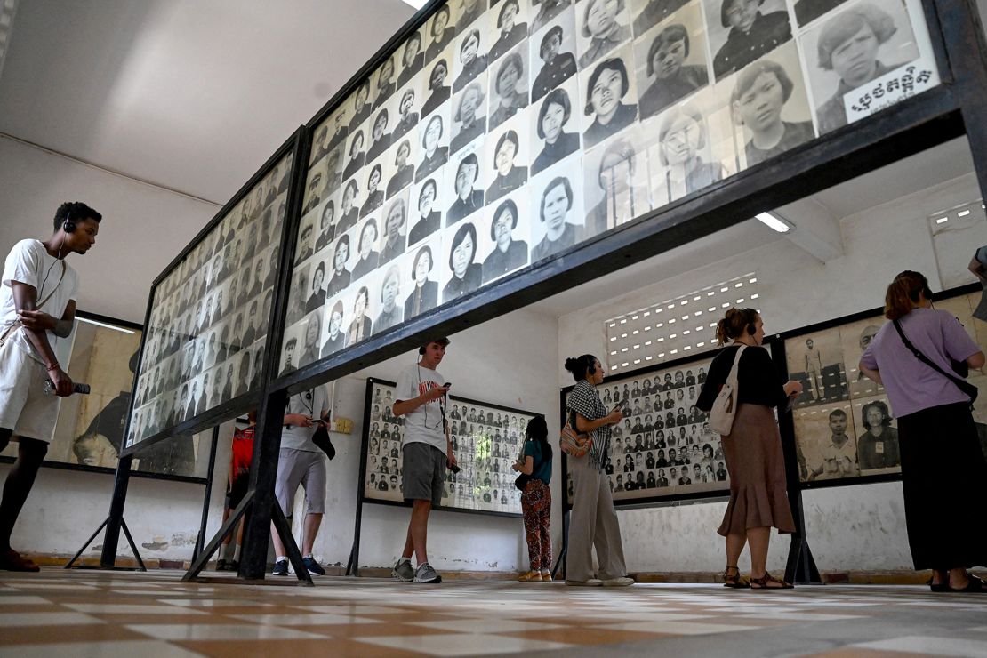 Tourists look at portrait photos of victims of the Khmer Rouge regime at the Tuol Sleng Genocide Museum in Phnom Penh.
