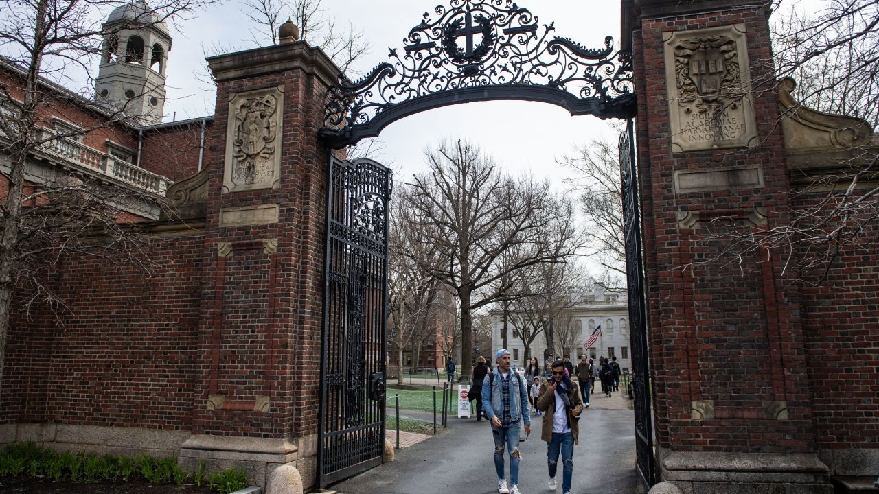 People walk through a gate as they exit Harvard Yard on the campus of Harvard University campus in Cambridge, Massachussetts, on April 15, 2025. Elite US university Harvard was hit with a $2.2 billion federal funding freeze on April 14 after rejecting a list of sweeping demands that the White House said was intended to crack down on campus anti-Semitism. The call for changes to its governance, hiring practices and issions procedures expands a list Harvard received on April 3, which ordered officials to shut diversity offices and cooperate with immigration authorities for screenings of international students. In a letter to students and faculty, Harvard president Alan Garber vowed to defy the government, insisting that the school would not "negotiate over its independence or its constitutional rights." (Photo by Joseph Prezioso / AFP) (Photo by JOSEPH PREZIOSO/AFP via Getty Images)