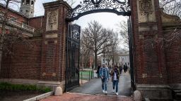 People walk through a gate as they exit Harvard Yard on the campus of Harvard University campus in Cambridge, Massachussetts, on April 15, 2025. Elite US university Harvard was hit with a $2.2 billion federal funding freeze on April 14 after rejecting a list of sweeping demands that the White House said was intended to crack down on campus anti-Semitism. The call for changes to its governance, hiring practices and admissions procedures expands a list Harvard received on April 3, which ordered officials to shut diversity offices and cooperate with immigration authorities for screenings of international students. In a letter to students and faculty, Harvard president Alan Garber vowed to defy the government, insisting that the school would not "negotiate over its independence or its constitutional rights." (Photo by Joseph Prezioso / AFP) (Photo by JOSEPH PREZIOSO/AFP via Getty Images)          