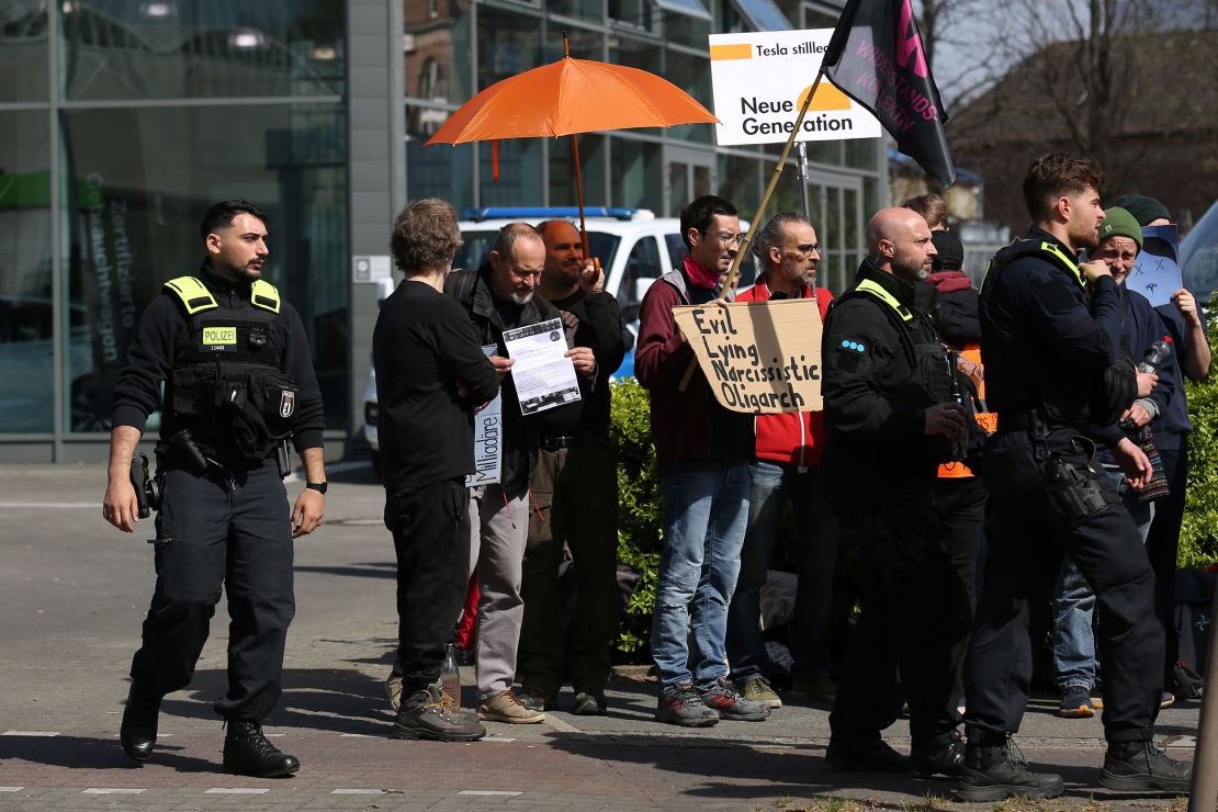 Activists of the Tesla Takedown movement protest outside a Tesla electric car showroom in Berlin, Germany. In Germany, many people are opposed to Tesla company owner Elon Musk's outspoken support of the far-right Alternative for Germany (AfD) political party.