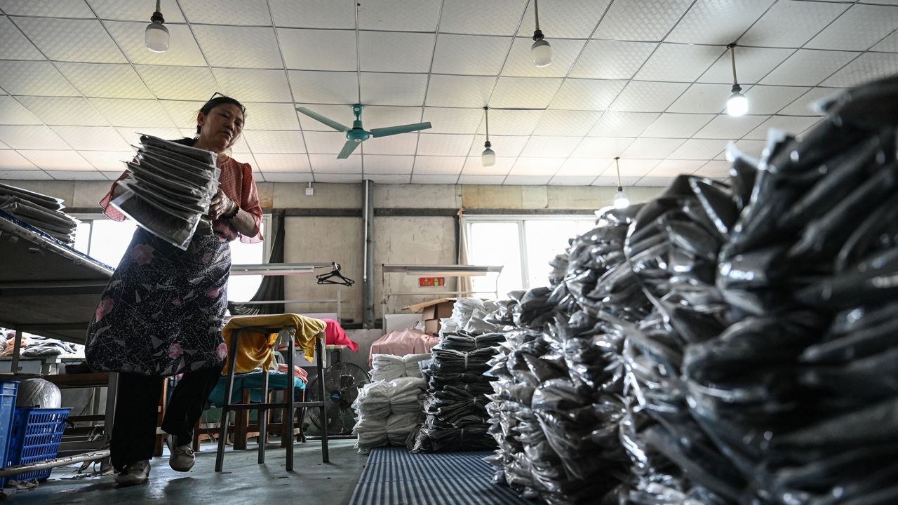 An employee sorts out garments for the online Chinese e-commerce company Temu at a clothing factory in Guangzhou, in southern China's Guangdong province on April 16, 2025. China told Washington on April 16 to "stop threatening and blackmailing" after US President Donald Trump said it was up to Beijing to come to the negotiating table to discuss ending their trade war. Trump has slapped new tariffs on friend and foe but has reserved his heaviest blows for China, with 145 percent on many Chinese imports even as Beijing has retaliated with levies on US goods of 125 percent.