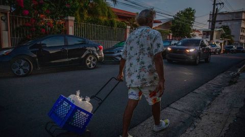 SAN JUAN, PUERTO RICO - APRIL 16: Roy Jiménez walks with three bags of ice for his refrigerator during a massive power blackout affected the entire island on April 16, 2025 in San Juan, Puerto Rico. The cause of the electricity outage is being investigated after all 1.4 million residents of the island lost power on Wednesday. (Photo by Jose Jimenez/Getty Images)