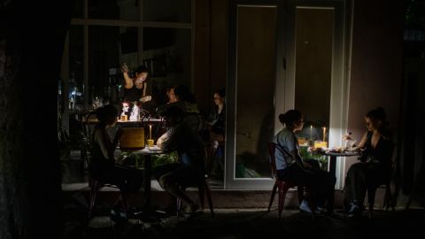 SAN JUAN, PUERTO RICO - APRIL 16: People have dinner at chinese restaurant Santurce during a massive power blackout that affected the entire island on April 16, 2025 in San Juan, Puerto Rico. The cause of the electricity outage is being investigated after all 1.4 million residents of the island lost power on Wednesday. (Photo by Jose Jimenez/Getty Images)