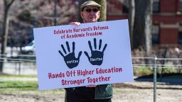 A Harvard Faculty member holds a sign as he exits Harvard Yard after a rally was held against President Donald Trump's attacks on Harvard University at Harvard University in Cambridge, Massachusetts on April 17, 2025. US President Donald Trump called Harvard a "joke" on April 16.2025, and said it should lose its government research contracts after the prestigious university refused demands that it accept outside political supervision. The Department of Homeland Security (DHS) also canceled $2.7 million worth of research grants to Harvard on Wednesday and threatened the university's ability to enroll international students unless it turns over records on visa-holders' "illegal and violent activities." (Photo by Joseph Prezioso / AFP) (Photo by JOSEPH PREZIOSO/AFP via Getty Images)          
