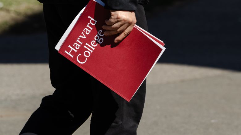 CAMBRIDGE, MASSACHUSETTS - APRIL 17: A person holds a Harvard College folder during a tour at Harvard University on April 17, 2025 in Cambridge, Massachusetts. The Trump istration announced that it would block Harvard University from receiving $2.2 billion in federal grants and $60 million in contracts after the school refused demands to adopt new policies relating to student and faculty conduct, issions, anti-semitism on campus and DEI. (Photo by Sophie Park/Getty Images)
