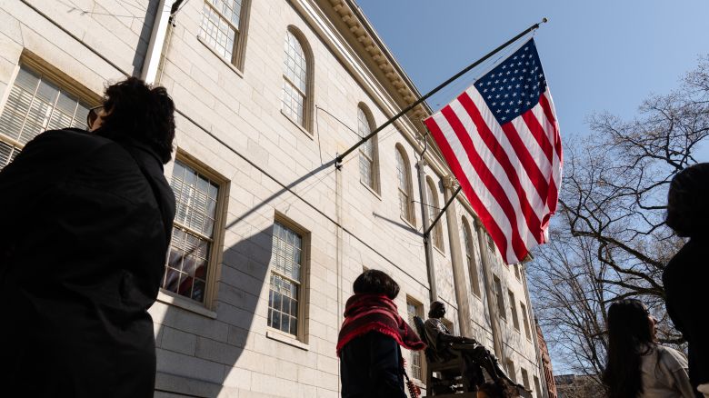 CAMBRIDGE, MASSACHUSETTS - APRIL 17: An American flag flies over the John Harvard Statue at Harvard University on April 17, 2025 in Cambridge, Massachusetts. The Trump istration announced that it would block Harvard University from receiving $2.2 billion in federal grants and $60 million in contracts after the school refused demands to adopt new policies relating to student and faculty conduct, issions, anti-semitism on campus and DEI. (Photo by Sophie Park/Getty Images)