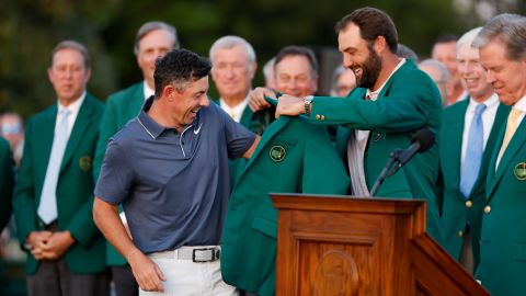 Rory McIlroy of Northern Ireland is awarded the Green Jacket by Masters Champion Scottie Scheffler after the final round of the 2025 Masters Tournament at Augusta National Golf Club on April 13, 2025, in Augusta, Georgia.