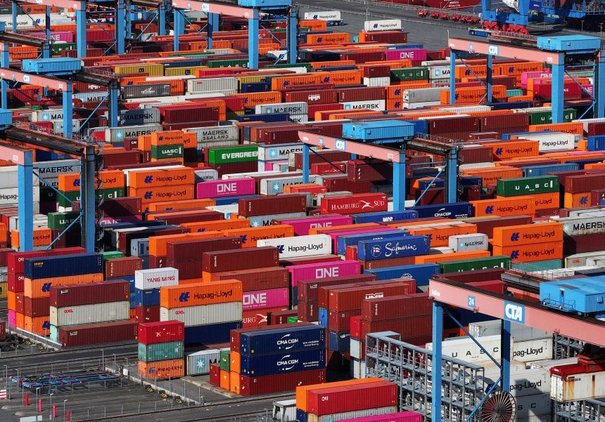 Traversing cranes move shipping containers stacked in Hamburg Port in Hamburg, Germany, on April 15.