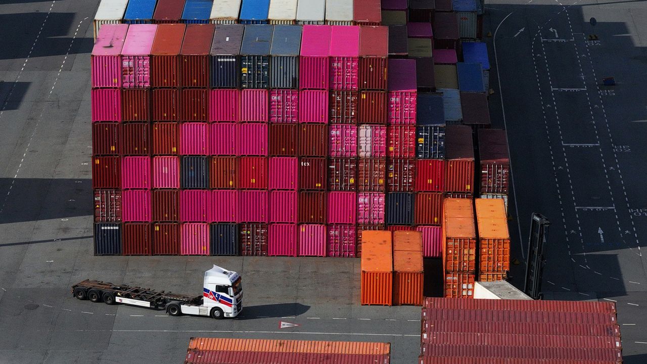 In this aerial view a truck drives among stacked shipping containers in Hamburg Port on April 15, 2025 in Hamburg, Germany. A 90-day pause by the European Union on reciprocal tariffs against the USA went into effect today. EU Trade Commissioner Maros Sefcovic was in Washington D.C. yesterday in an effort to negotiate with the administration of U.S. President Donald Trump over defusing the the threat of escalating tariffs.