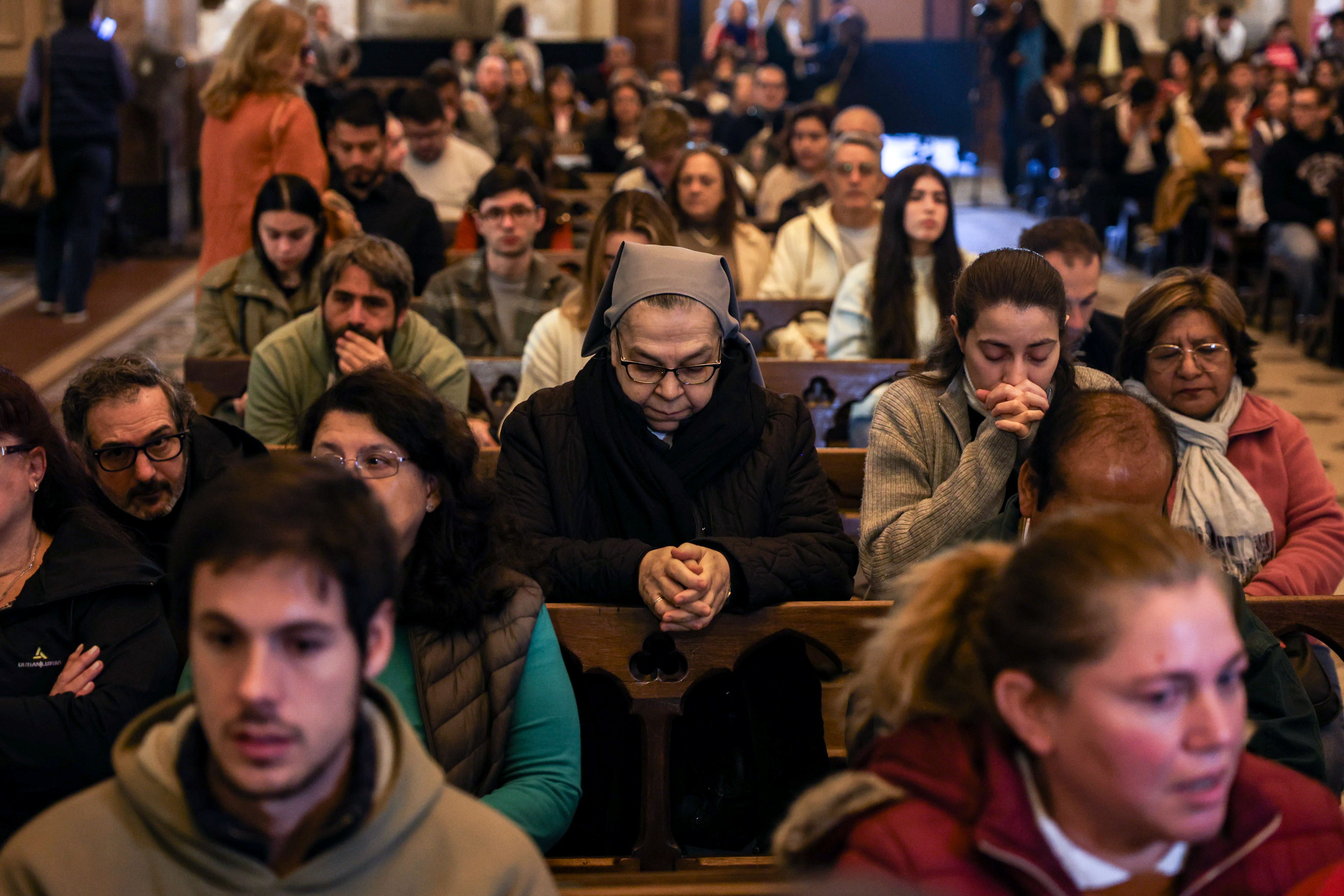 People pray during a service in Buenos Aires.
