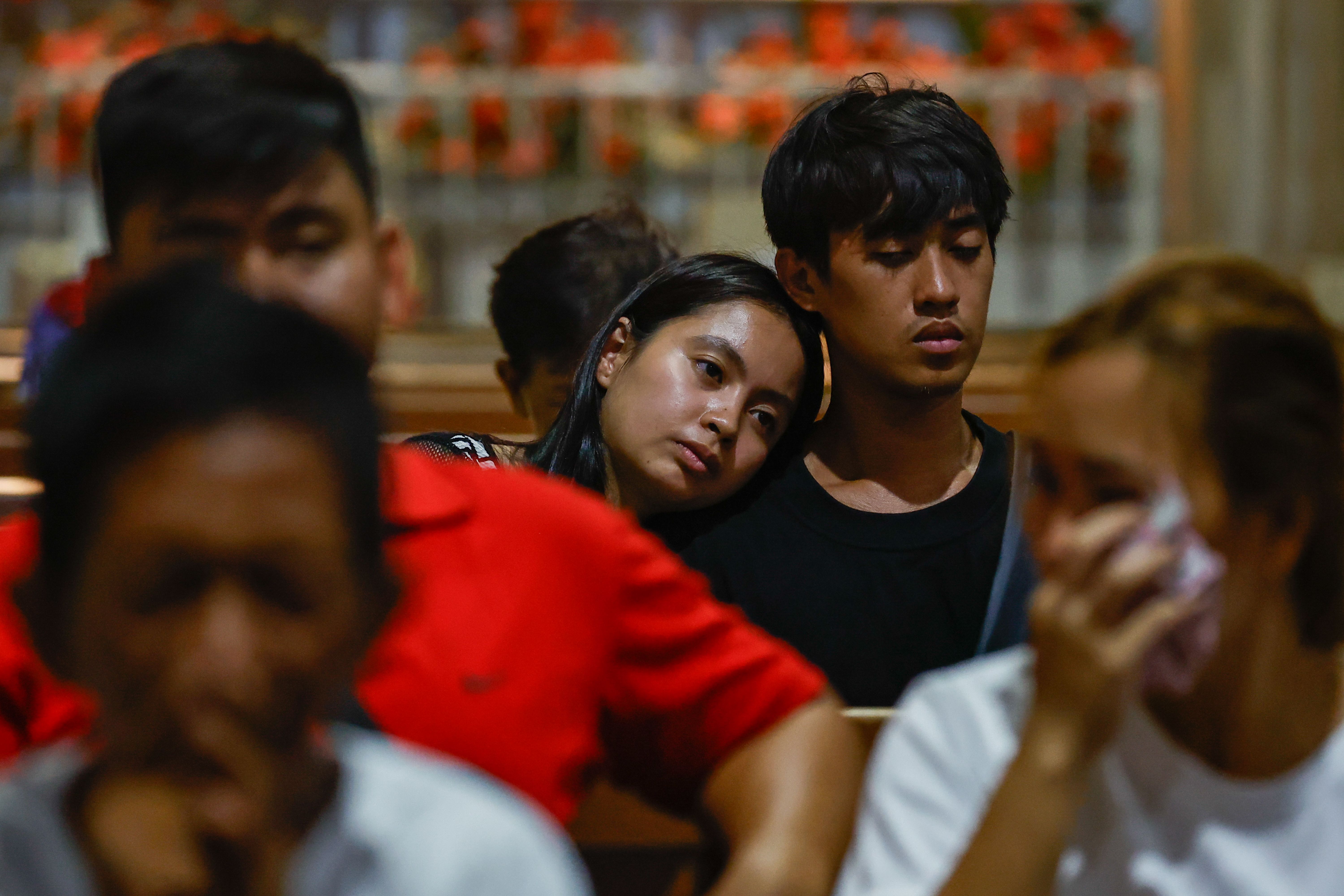 People mourn the pope at a church in Quezon City, Philippines.