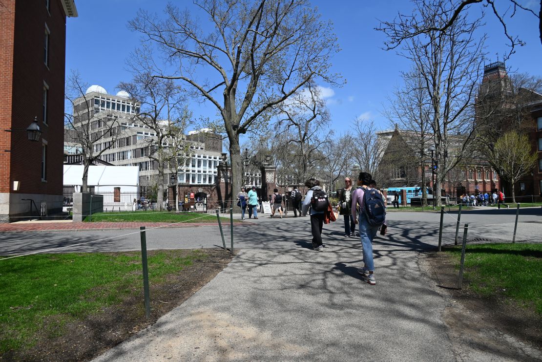Students walk across campus April 22 at Harvard University.