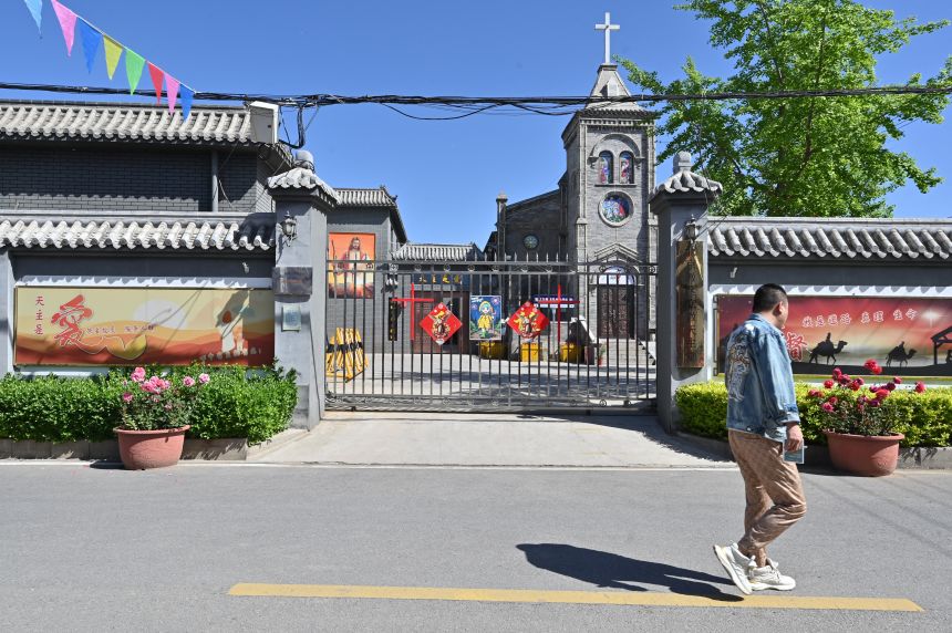 A man walks past a Catholic church in Lijiao village, China's northern Hebei province on April 22, 2025.