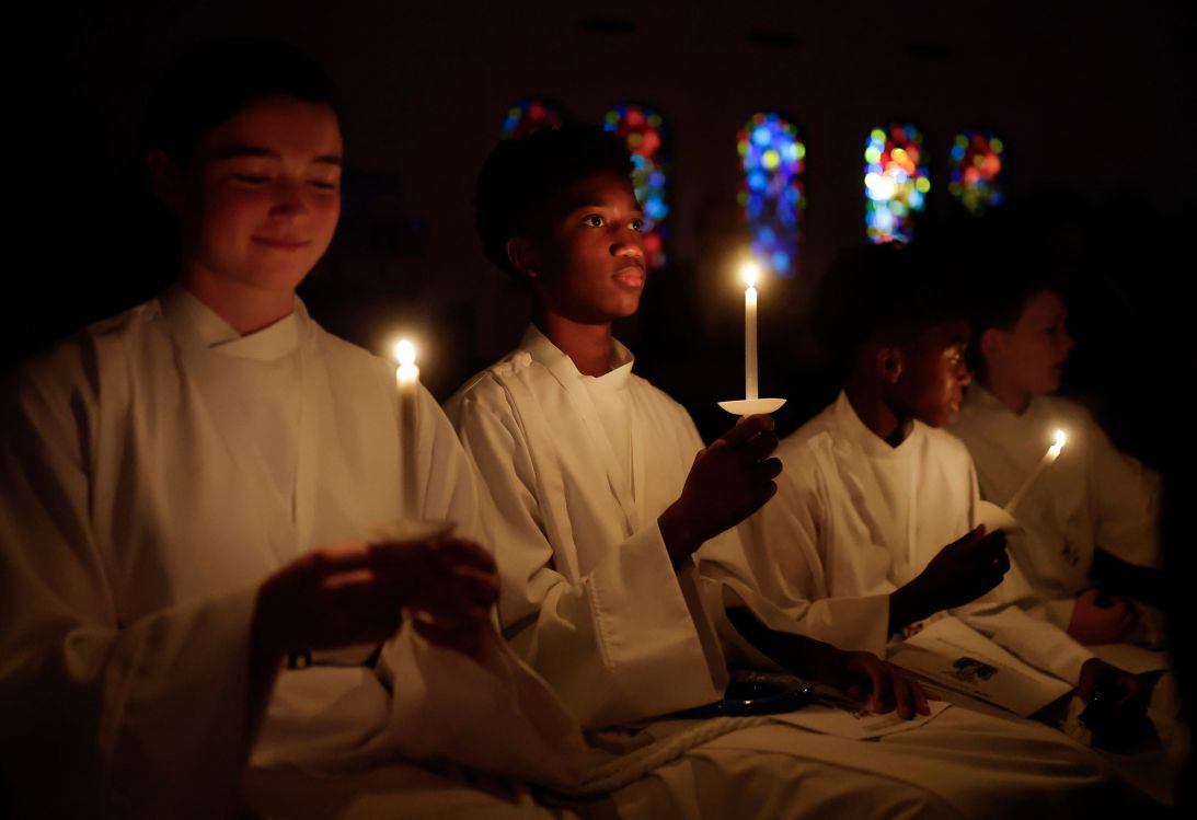 Acolytes hold candles during an Easter vigil service on April 19, 2025, at St. Barnabas Episcopal Church in Eagle Rock, California.