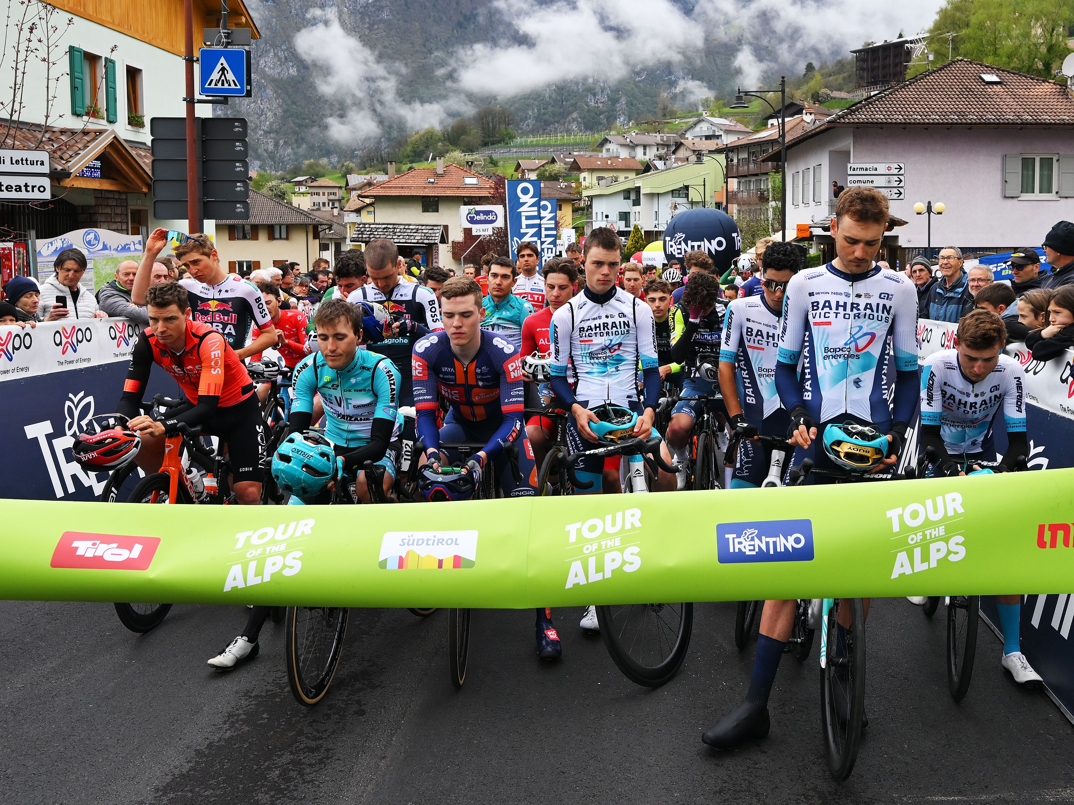 Cyclists observe a moment of silence for the pope before the 45th Tour of the Alps in San Lorenzo Dorsino, Italy.