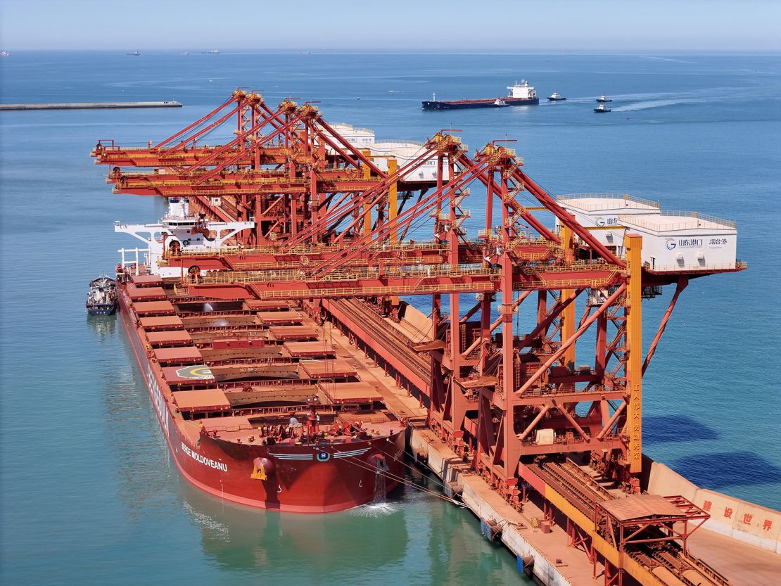 A cargo ship unloads at the ore terminal in the West Port Area of Yantai Port in Shandong province, China, on April 25, 2025.