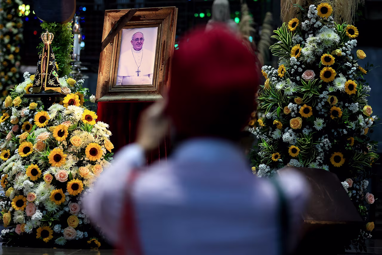 A faithful takes photos of a portrait of the late Pope Francis displayed at the Rio de Janeiro Metropolitan Cathedral on Monday in Rio de Janeiro, Brazil.