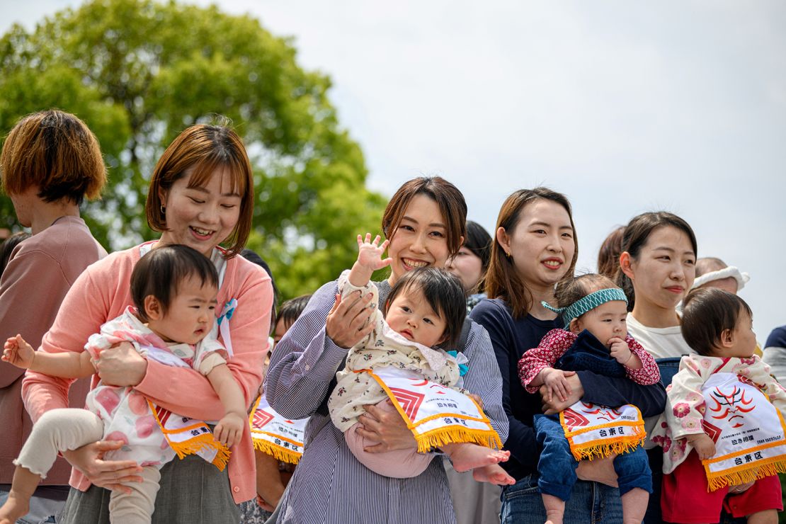 Parents hold their children before the start of their 