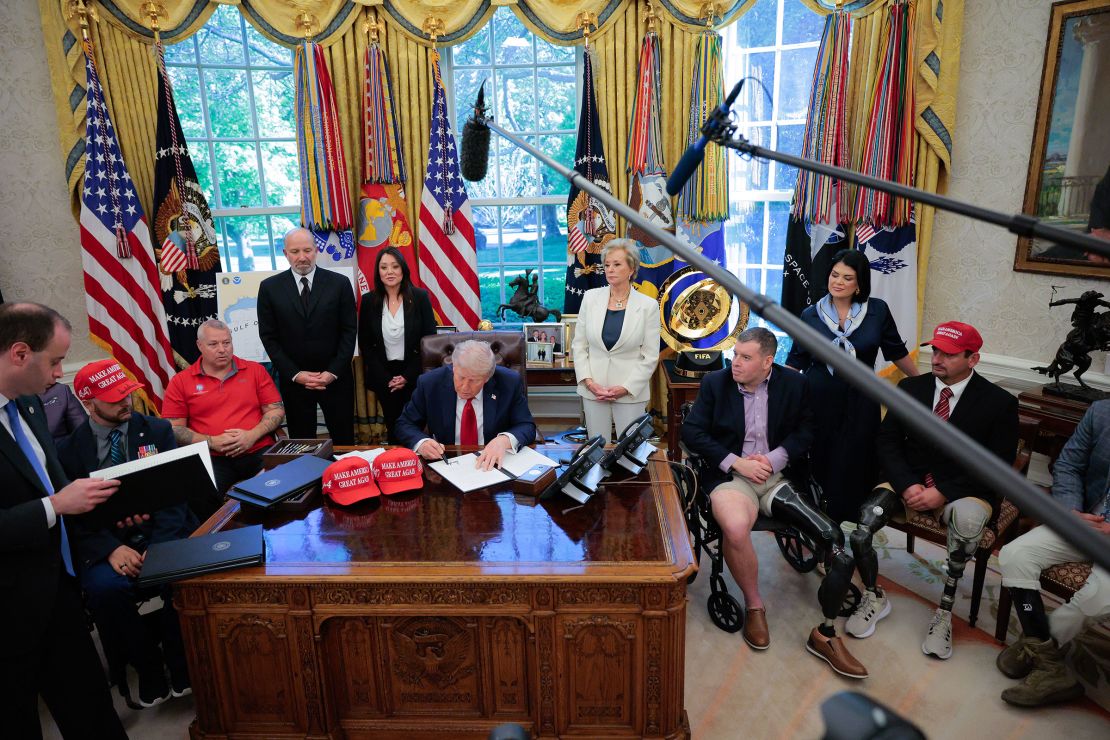 President Donald Trump signs executive orders in the Oval Office of the White House on April 23.