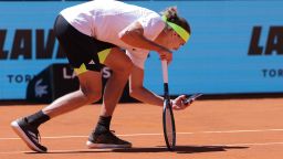 Germany's Alexander Zverev takes a picture with his mobile phone of the ball mark on the court after he disputed the referee decision during his match against Spain's Alejandro Davidovich Fokina during their 2025 ATP Tour Madrid Open tennis tournament third round singles match at the Caja Magica in Madrid, on April 27, 2025. (Photo by Thomas COEX / AFP) (Photo by THOMAS COEX/AFP via Getty Images)          