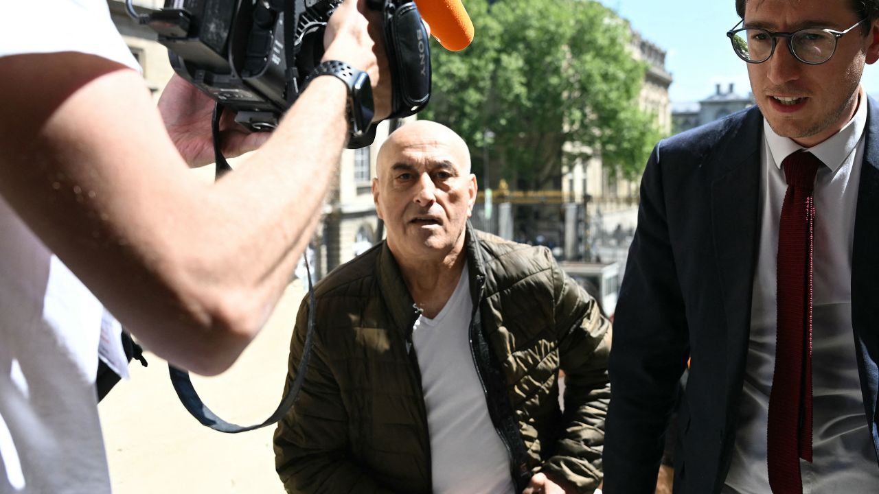 Defendant Yunice Abbas (C) and his lawyer Gabriel Dumenil arrive for the start of the trial for the 2016 robbery and kidnapping of US celebrity Kim Kardashian at the Assize Court of Paris, on April 28, 2025. At the beginning of October 2016, the queen of influencers Kim Kardashian was robbed in her hotel room at the height of fashion week by elderly thugs who arrived on bicycles and disguised as police officers: the trial of this sensational nine million euro jewellery robbery opened in Paris on April 28, 2025. (Photo by Bertrand GUAY / AFP) (Photo by BERTRAND GUAY/AFP via Getty Images)