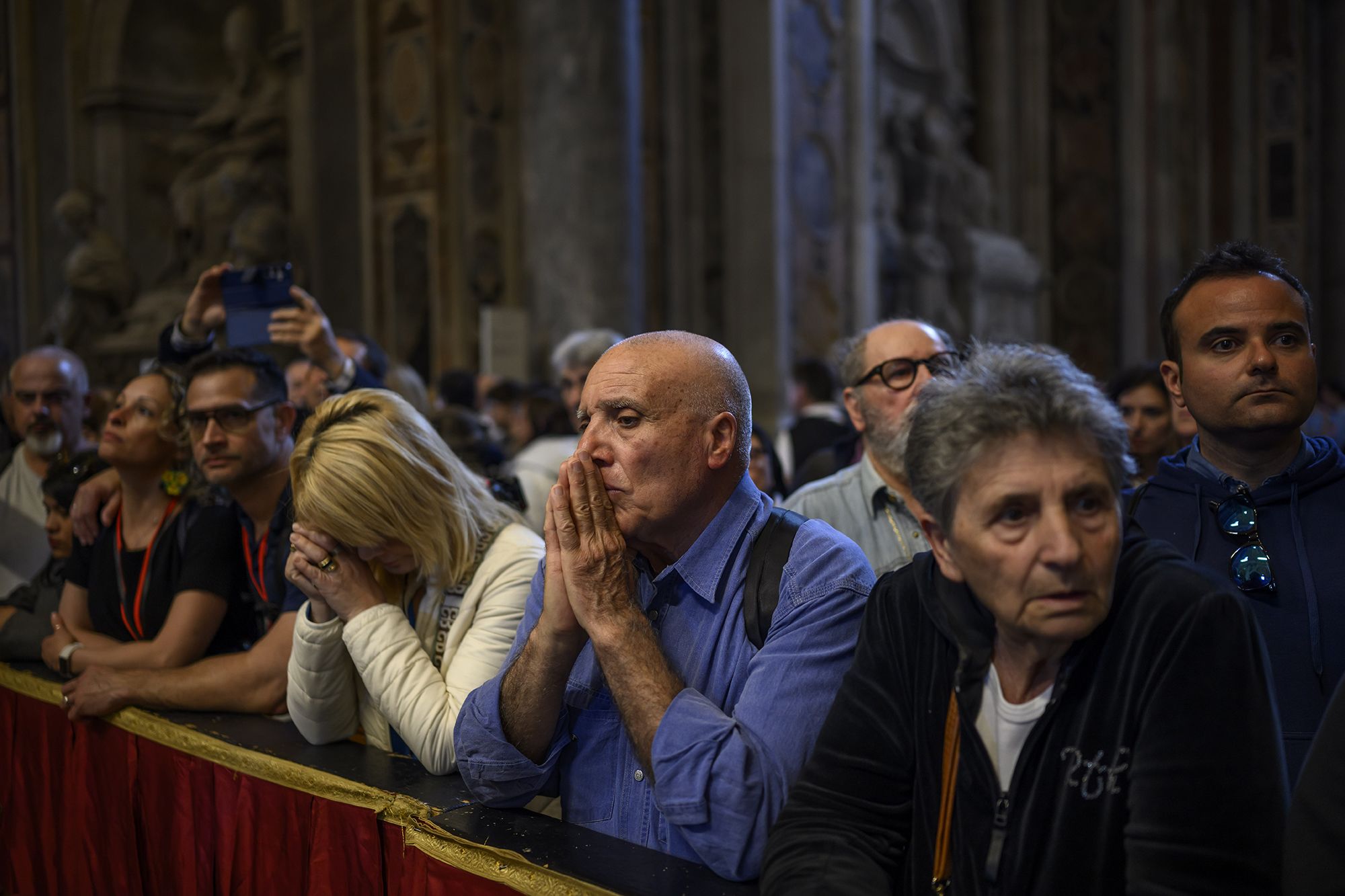 Faithful pay their respects to the pope in St. Peter's Basilica on Friday.