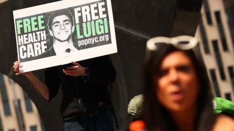 NEW YORK, NEW YORK - APRIL 25: People gather at Foley Square to  Luigi Mangione, accused gunman in the killing of UnitedHealthcare CEO Brian Thompson, as he is arraigned on federal charges at Manhattan Federal Court on April 25, 2025 in New York City. Mangione appeared in federal court and entered a not guilty plea on charges of stalking and murder. He appeared in court a week after a federal grand jury indicted him on four federal charges in the December 4 killing of the insurance executive Brian Thompson. Attorney General Pam Bondi has announced that the Justice Department has filed a notice that they intend to seek the death penalty in the case. Mangione also faces state charges in New York and Pennsylvania related to the shooting and its week long manhunt. (Photo by Michael M. Santiago/Getty Images)