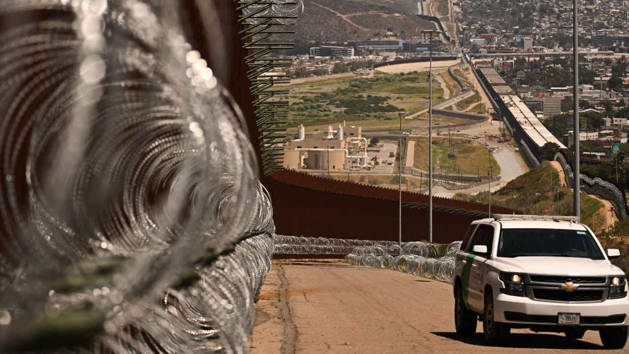 A US Customs and Border Protection (CBP) Border Patrol vehicle drives past recently installed concertina wire on a section of border wall fencing along the US-Mexico border between San Diego and Tijuana in San Diego, California on April 24, 2025. (Photo by Patrick T. Fallon / AFP) (Photo by PATRICK T. FALLON/AFP via Getty Images)          