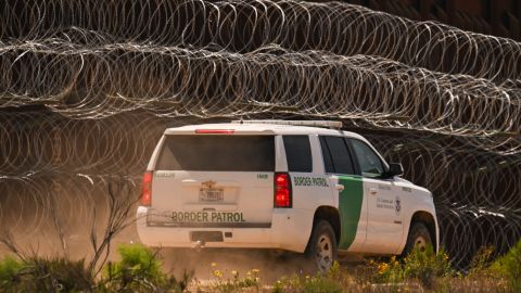 A US Customs and Border Protection (CBP) Border Patrol vehicle drives past recently installed concertina wire on a section of border wall fencing along the US-Mexico border between San Diego and Tijuana in San Diego, California on April 24, 2025. (Photo by Patrick T. Fallon / AFP) (Photo by PATRICK T. FALLON/AFP via Getty Images)          