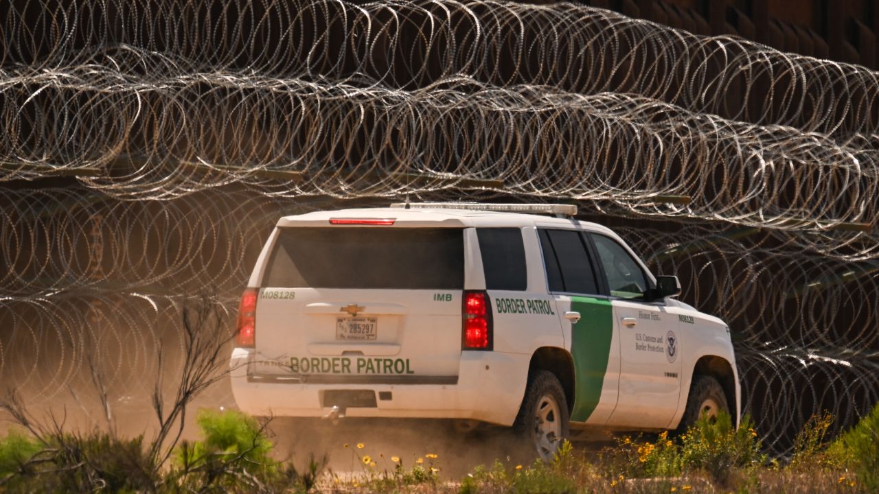 A US Customs and Border Protection (CBP) Border Patrol vehicle drives past recently installed concertina wire on a section of border wall fencing along the US-Mexico border between San Diego and Tijuana in San Diego, California on April 24, 2025. (Photo by Patrick T. Fallon / AFP) (Photo by PATRICK T. FALLON/AFP via Getty Images)          