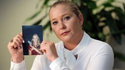 Virginia Giuffre holds a photo of her younger self.